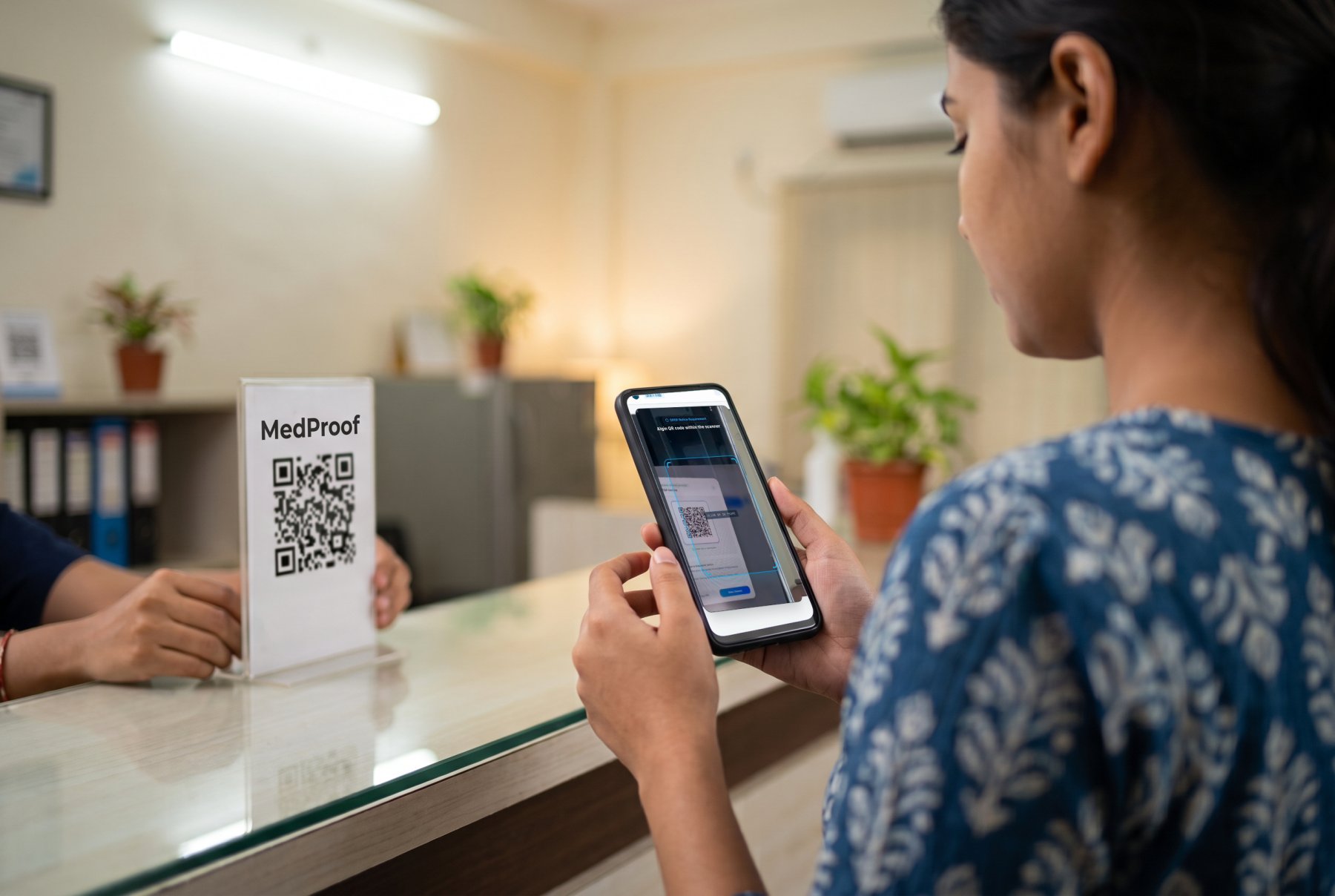 A patient scanning the MedProof code with her phone camera